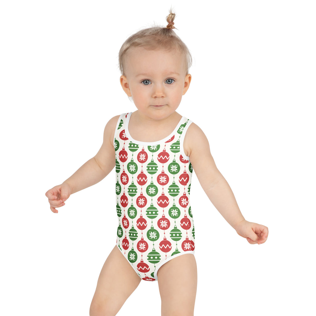 White one-piece swimsuit featuring a festive red and green christmas ornaments pattern with uppf 50+ for girls