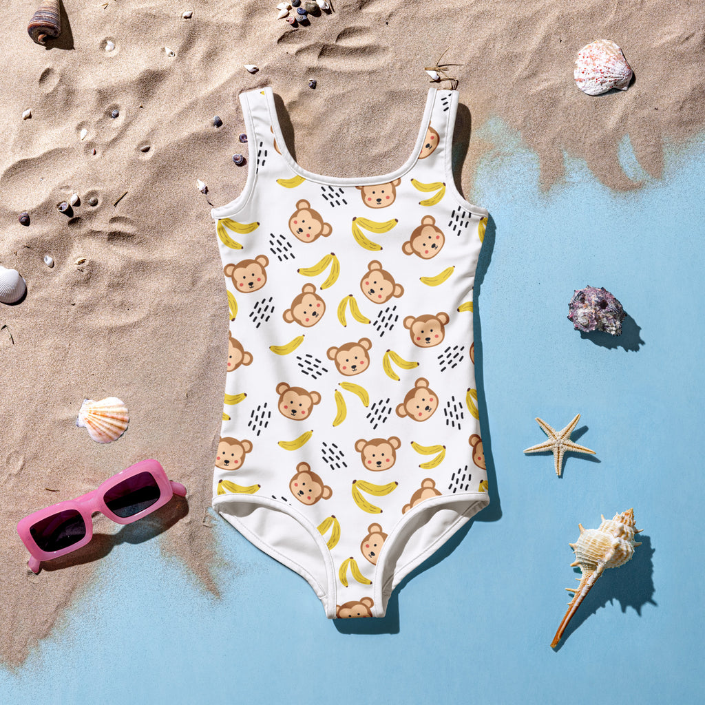 White buttery soft girls one-piece swimsuit with monkeys and bananas pattern and upf 50+ sun protection