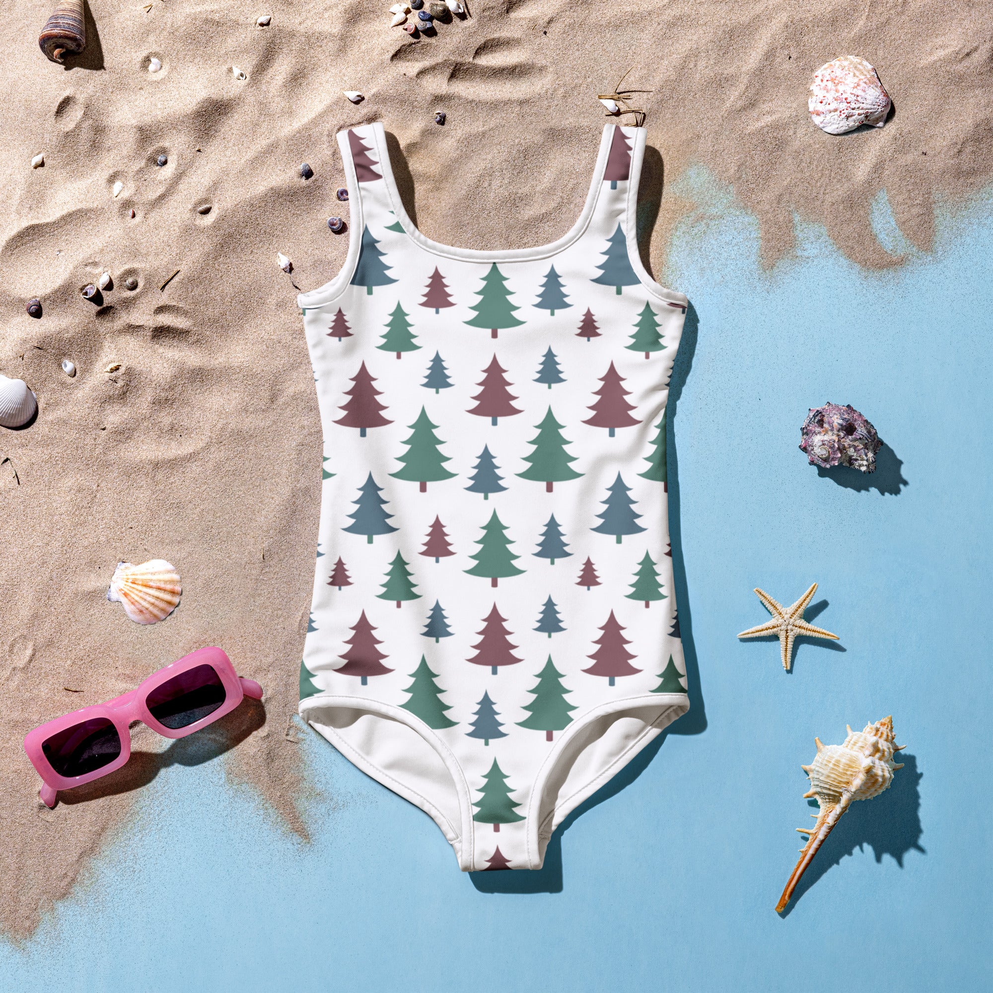 A white buttery soft girls one-piece swimsuit with evergreen tree pattern and UPF 50 plus sun protection