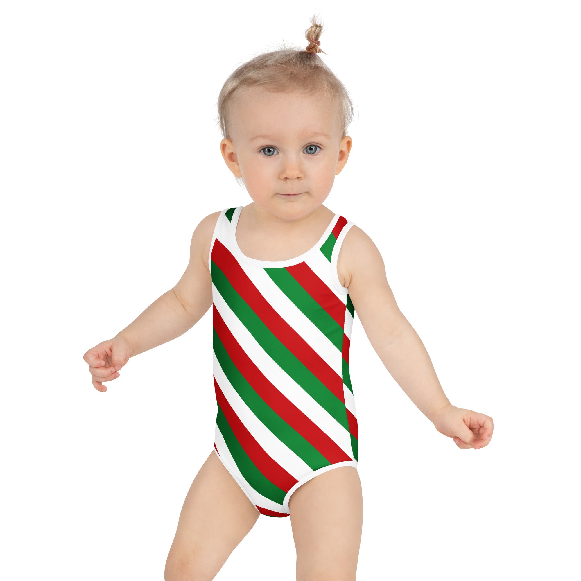 A toddler wearing a girls candy cane striped christmas buttery soft swimsuit with upf 50 plus in red and green