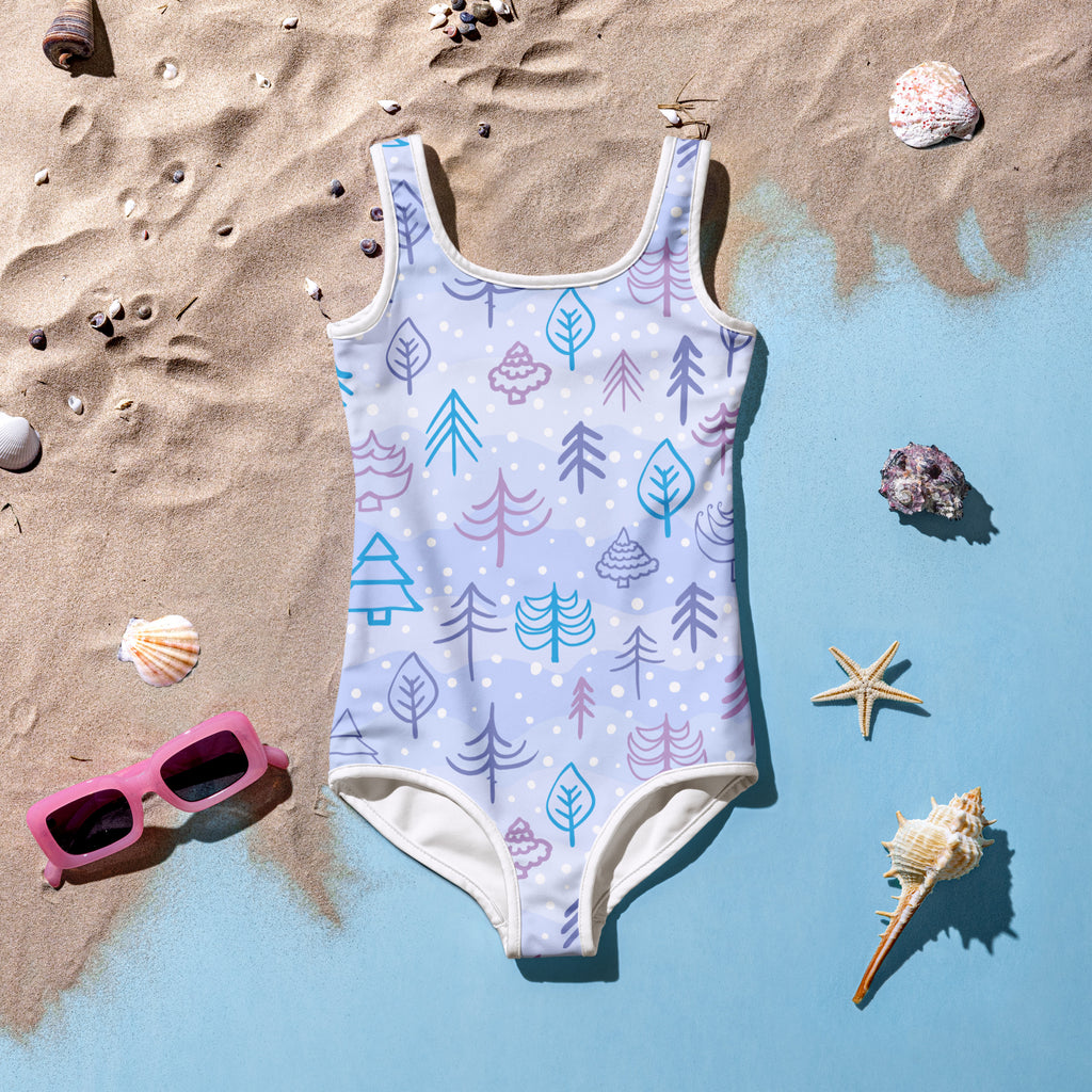 A light blue girls winter forest buttery soft swimsuit with playful teal purple and pink tree and leaf patterns and UPF 50+