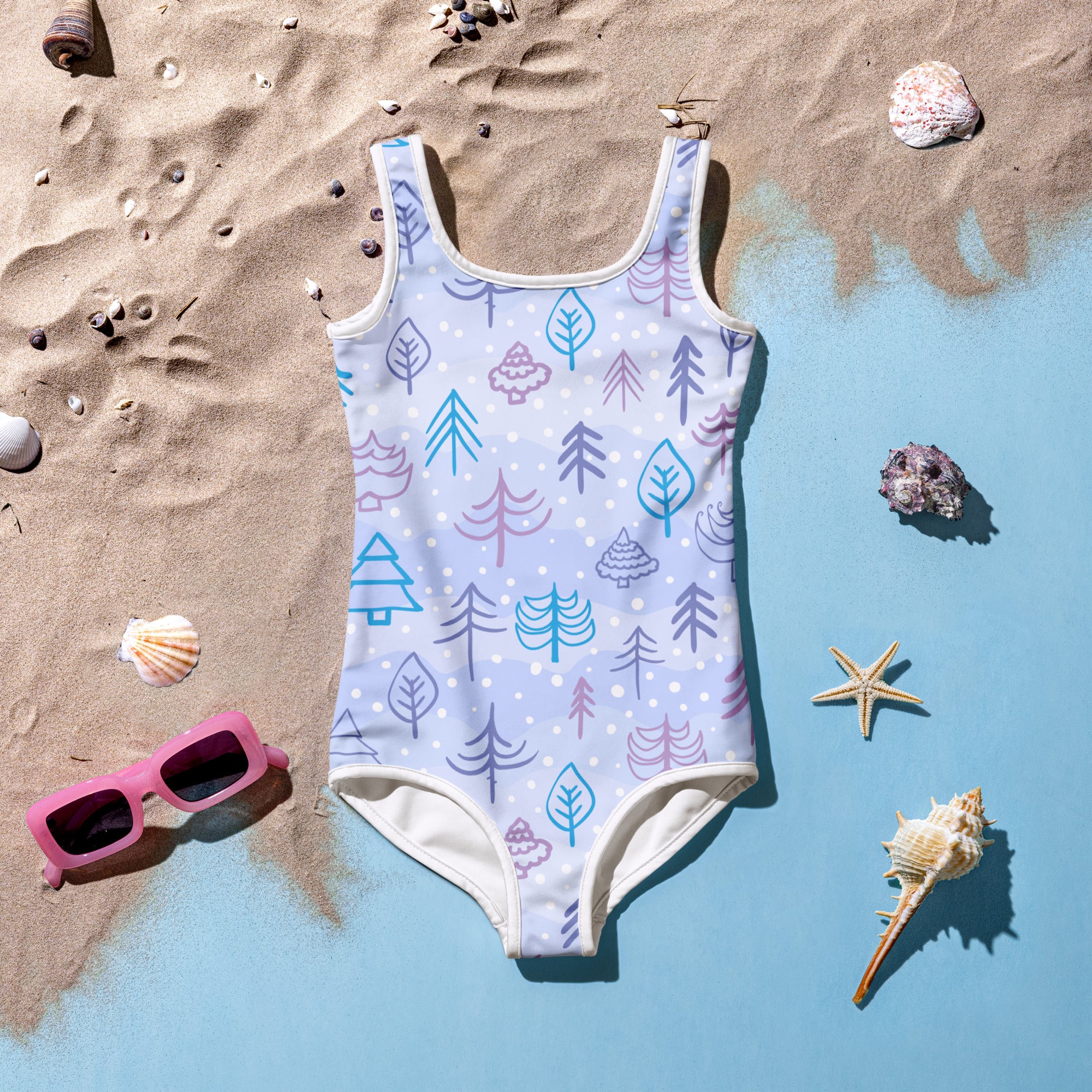 A light blue girls winter forest buttery soft swimsuit with playful teal purple and pink tree and leaf patterns and UPF 50+