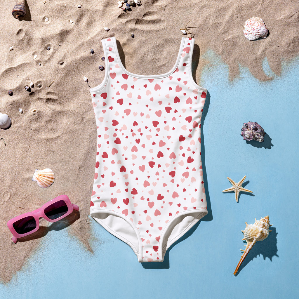 Girls pink hearts buttery soft white one-piece swimsuit with playful pink and red hearts pattern and UPF 50+ protection