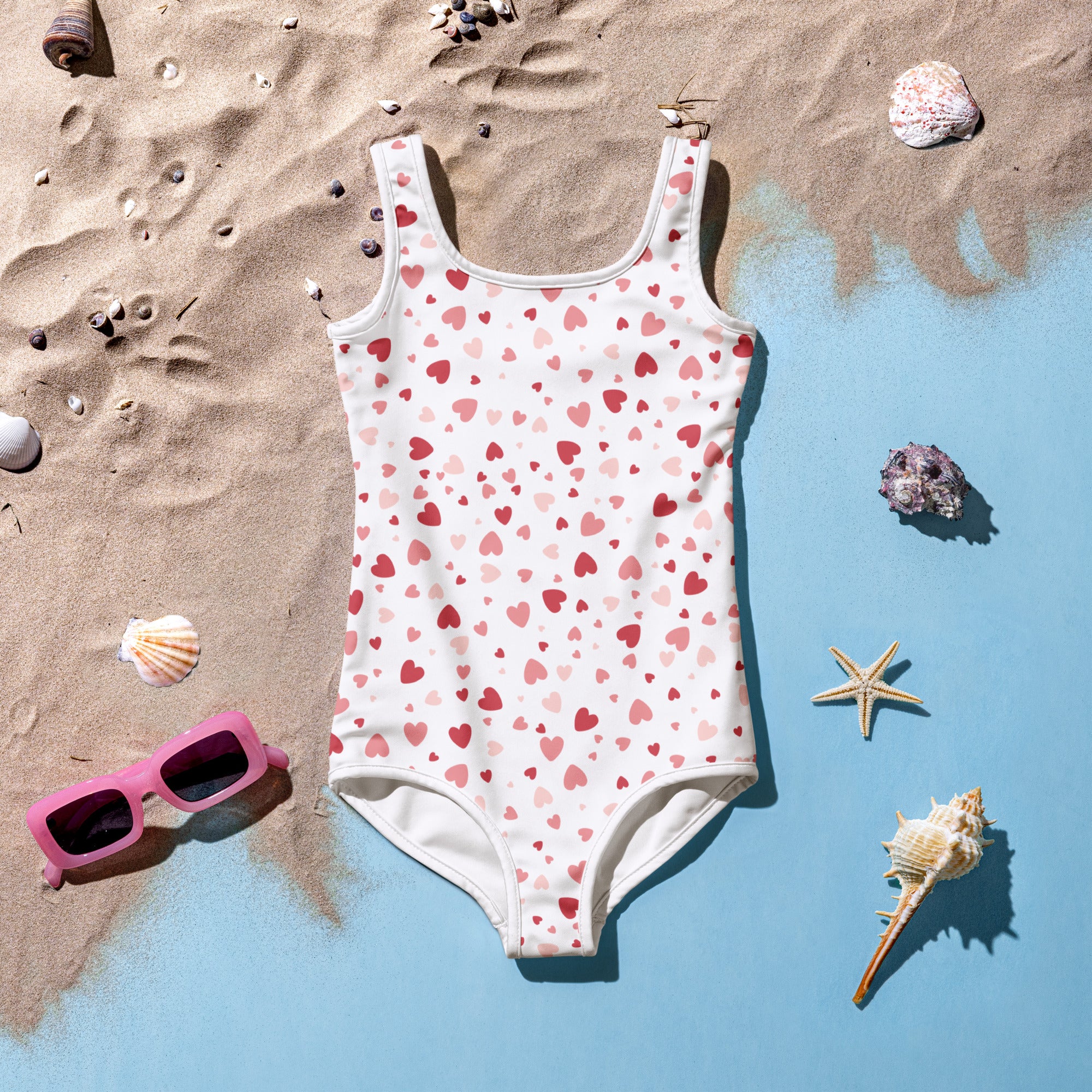 Girls pink hearts buttery soft white one-piece swimsuit with playful pink and red hearts pattern and UPF 50+ protection