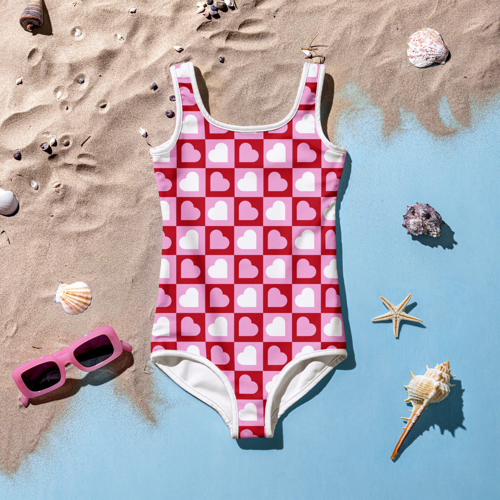 Girls pink heart squares checkerboard buttery soft one-piece swimsuit with white trim and UPF 50 plus protection