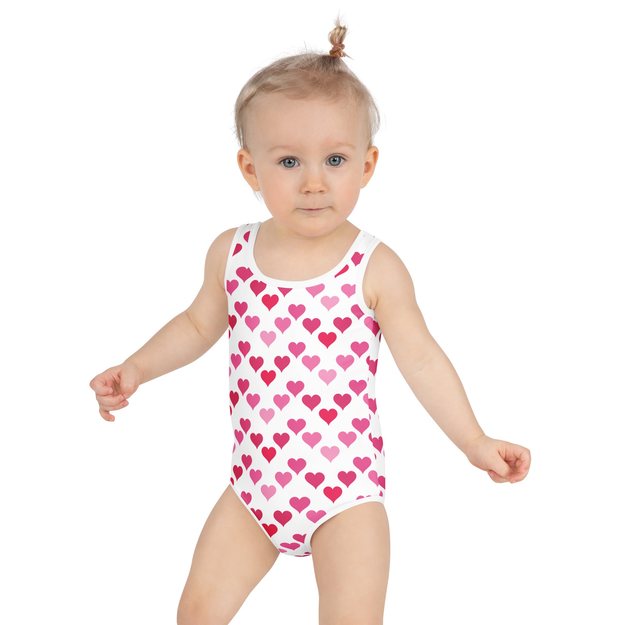 A white girls one-piece swimsuit with pink heart pattern buttery soft fabric and UPF 50 plus sun protection