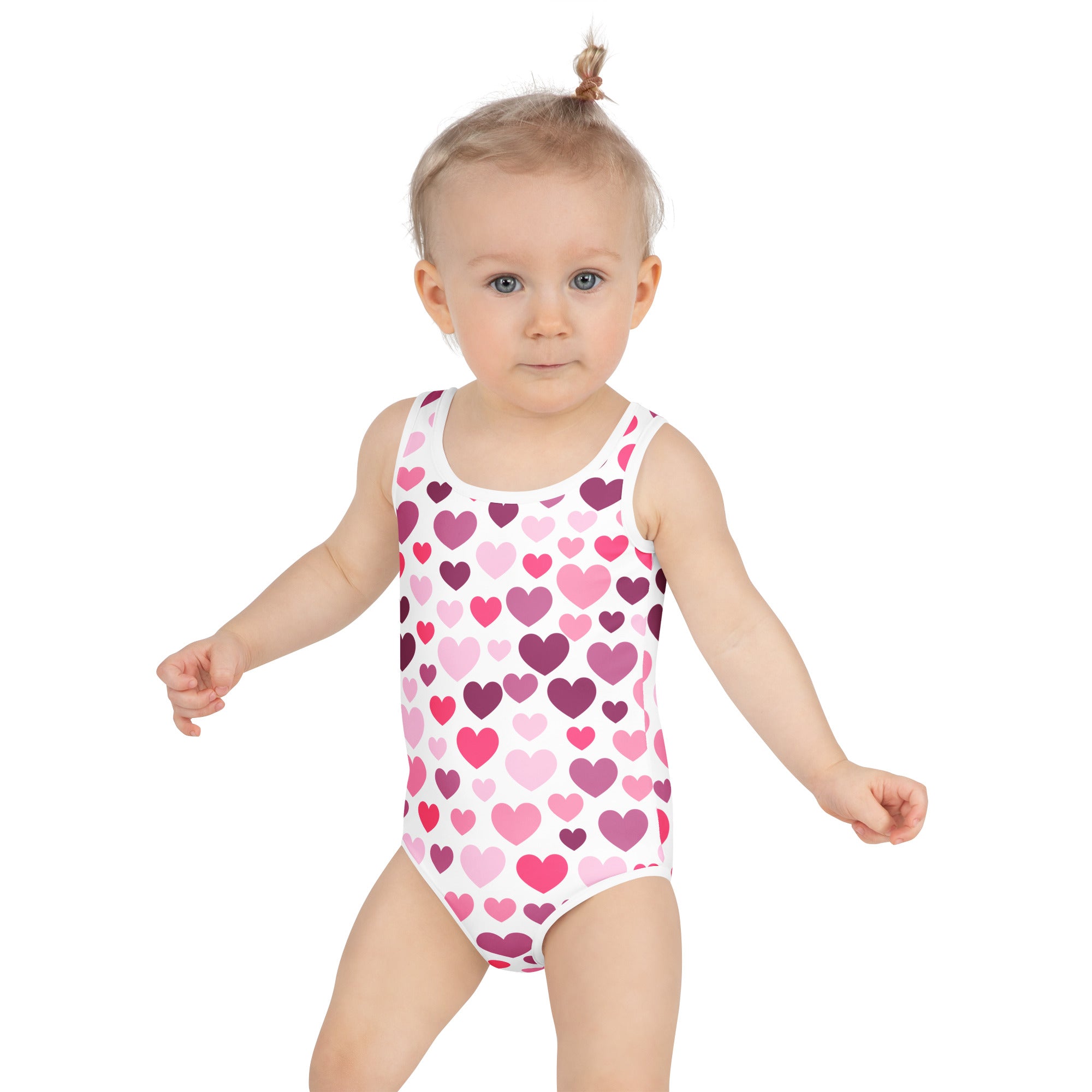 A white one-piece girls swimsuit with pink and purple hearts buttery soft fabric UPF 50 plus double layered front