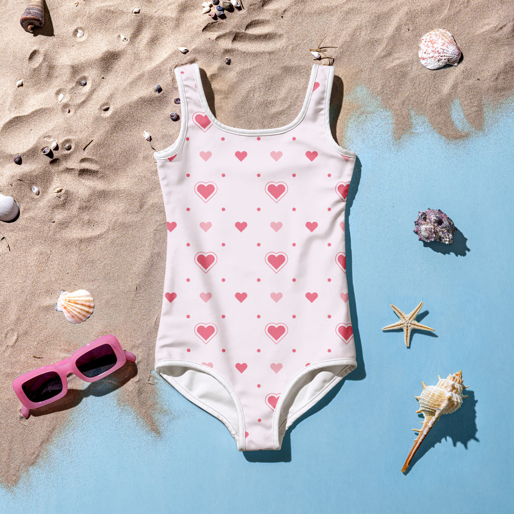 A white girls one-piece swimsuit with pink hearts and dots soft pink buttery soft fabric upf 50 plus double layered front