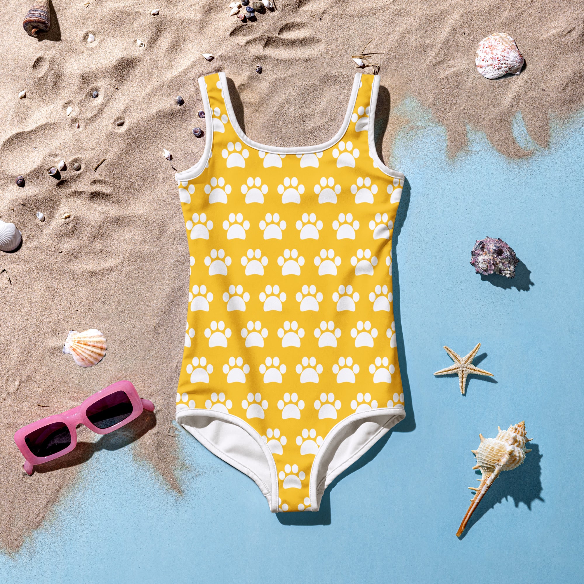 A girls yellow paw print buttery soft one-piece swimsuit with white trim and UPF 50 plus protection