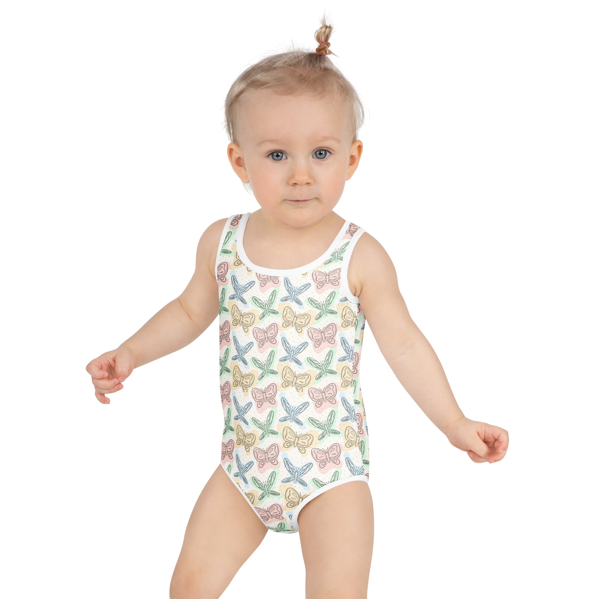 A white one-piece girls swimsuit with pastel butterfly and dragonfly print made of buttery soft fabric with upf 50+ protection
