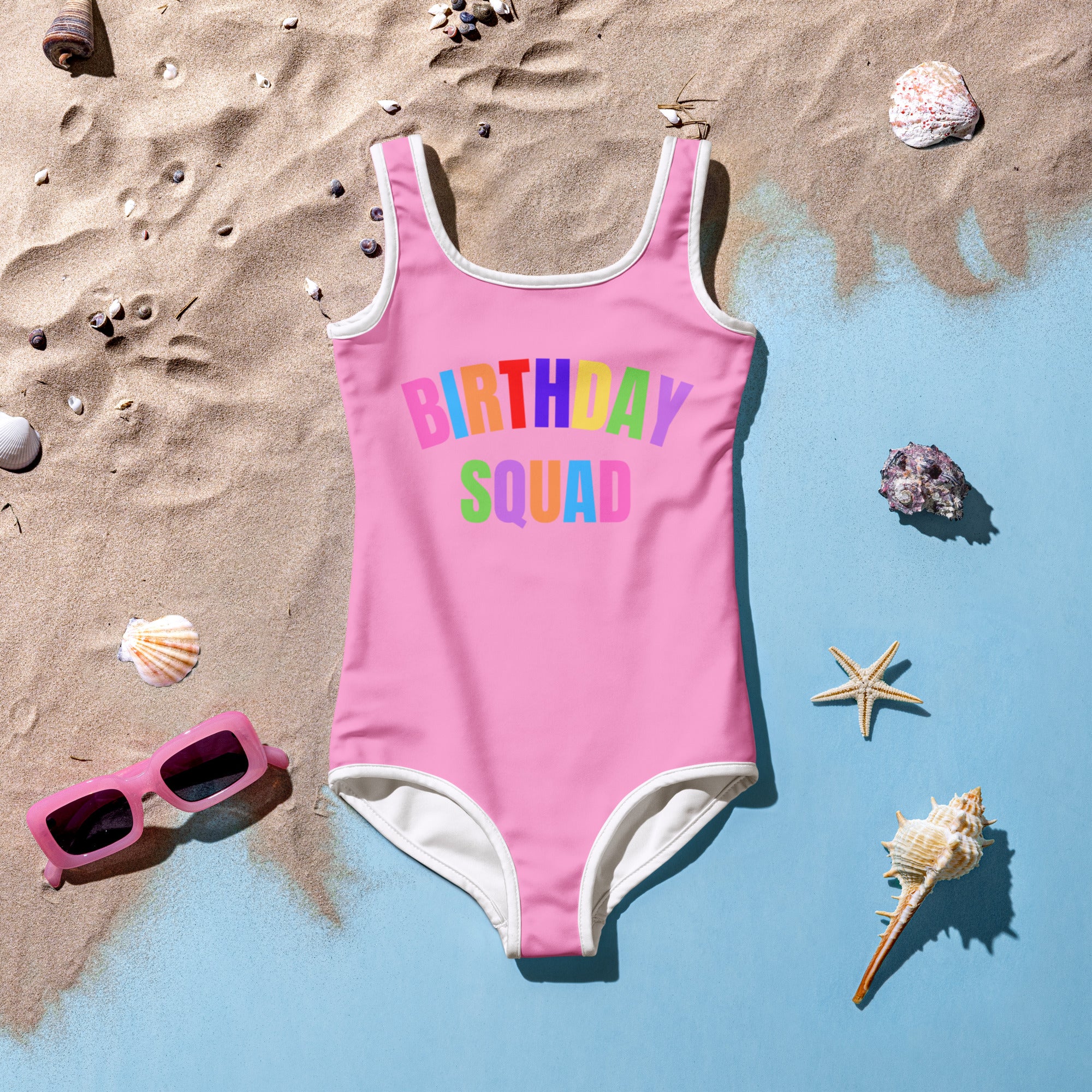 Pink girls birthday squad buttery soft swimsuit with white trim and rainbow print upf 50 plus double layered front