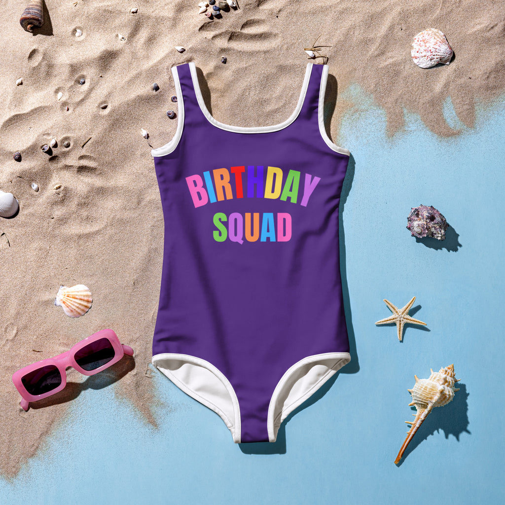 Purple girls birthday squad buttery soft one-piece swimsuit with white trim rainbow letters and upf 50 plus protection