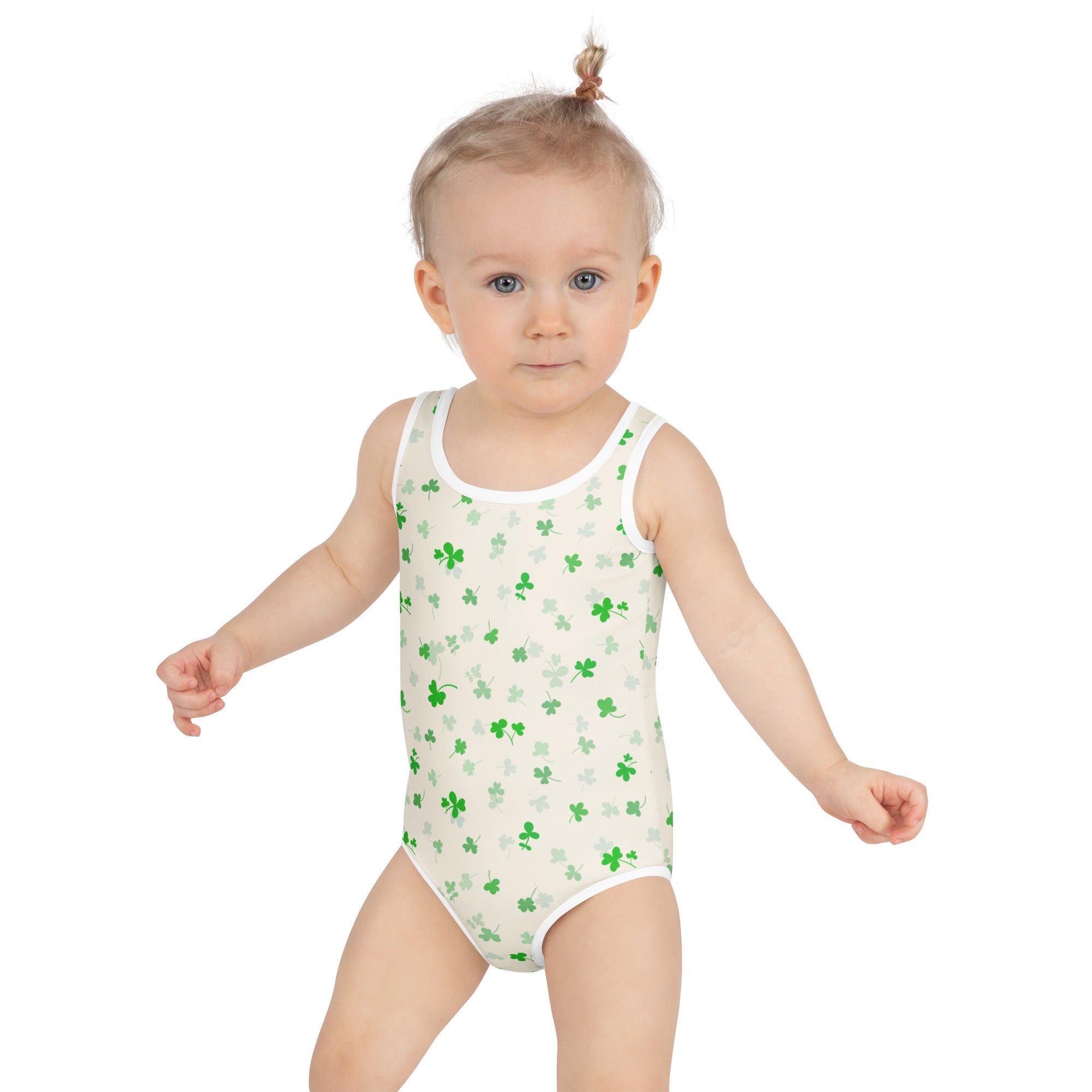 A child wearing a white one-piece girls soft green shamrock buttery soft swimsuit with UPF 50+ and double layered front