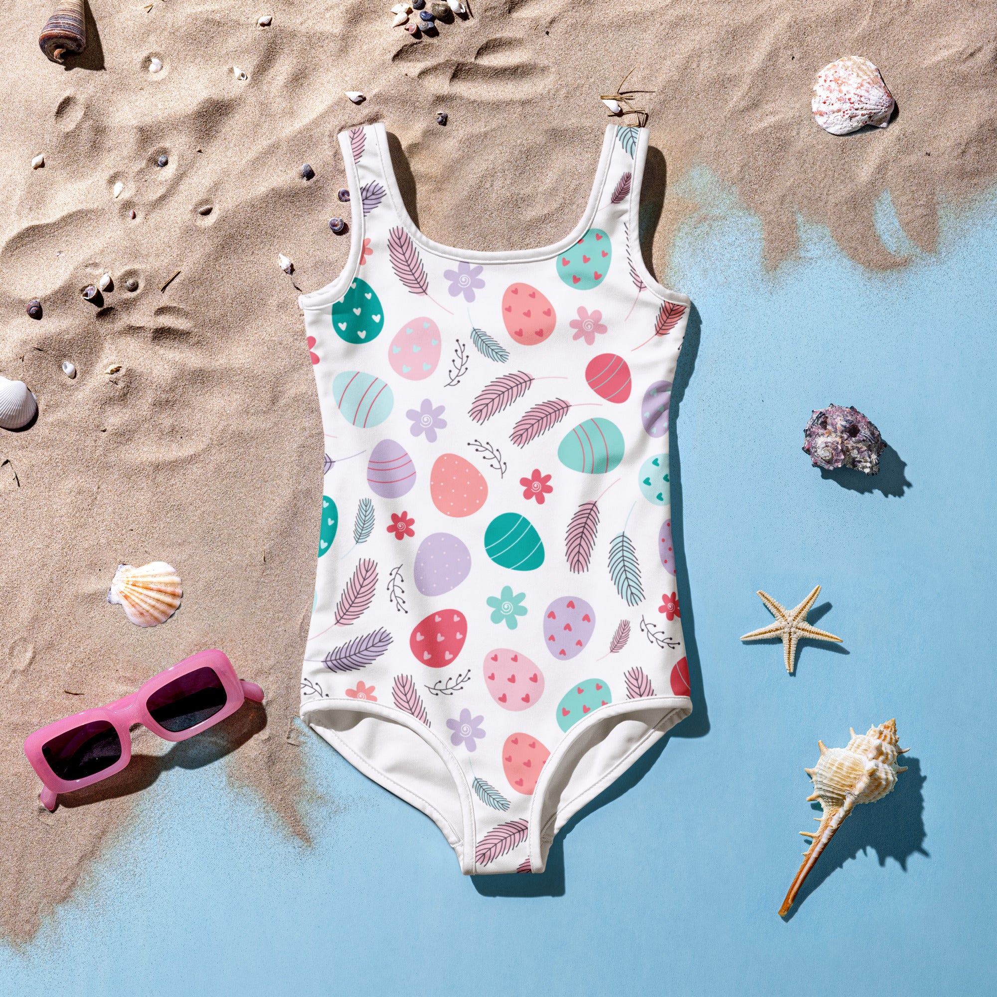A white girls one-piece swimsuit with pastel Easter eggs feathers flowers pattern buttery soft UPF 50 plus double layered front