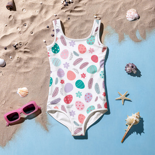 A white girls one-piece swimsuit with pastel Easter eggs feathers flowers pattern buttery soft UPF 50 plus double layered front