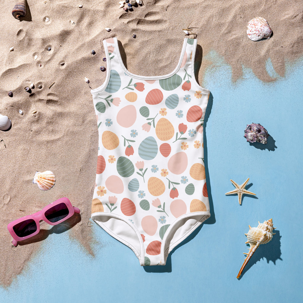 Girls pastel easter egg pattern buttery soft white one-piece swimsuit with double layered front and UPF 50 plus protection