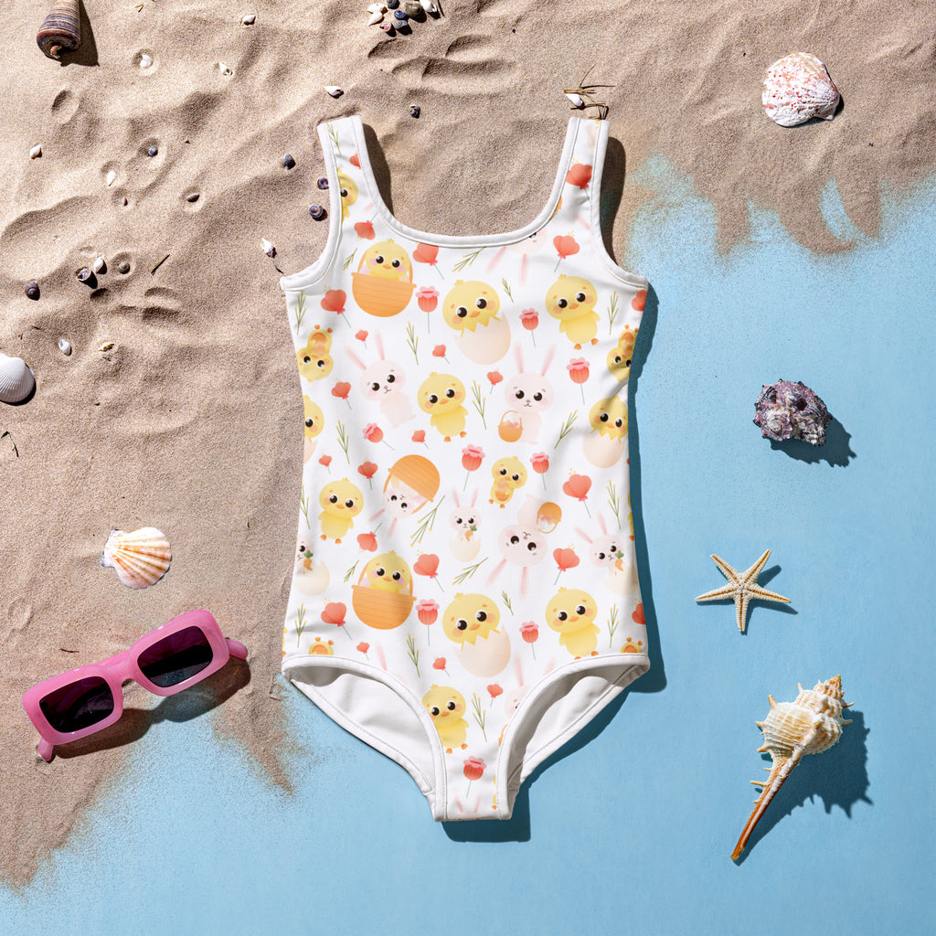 A white girls one-piece swimsuit with yellow chicks orange eggs pink flowers buttery soft fabric and UPF 50+ protection