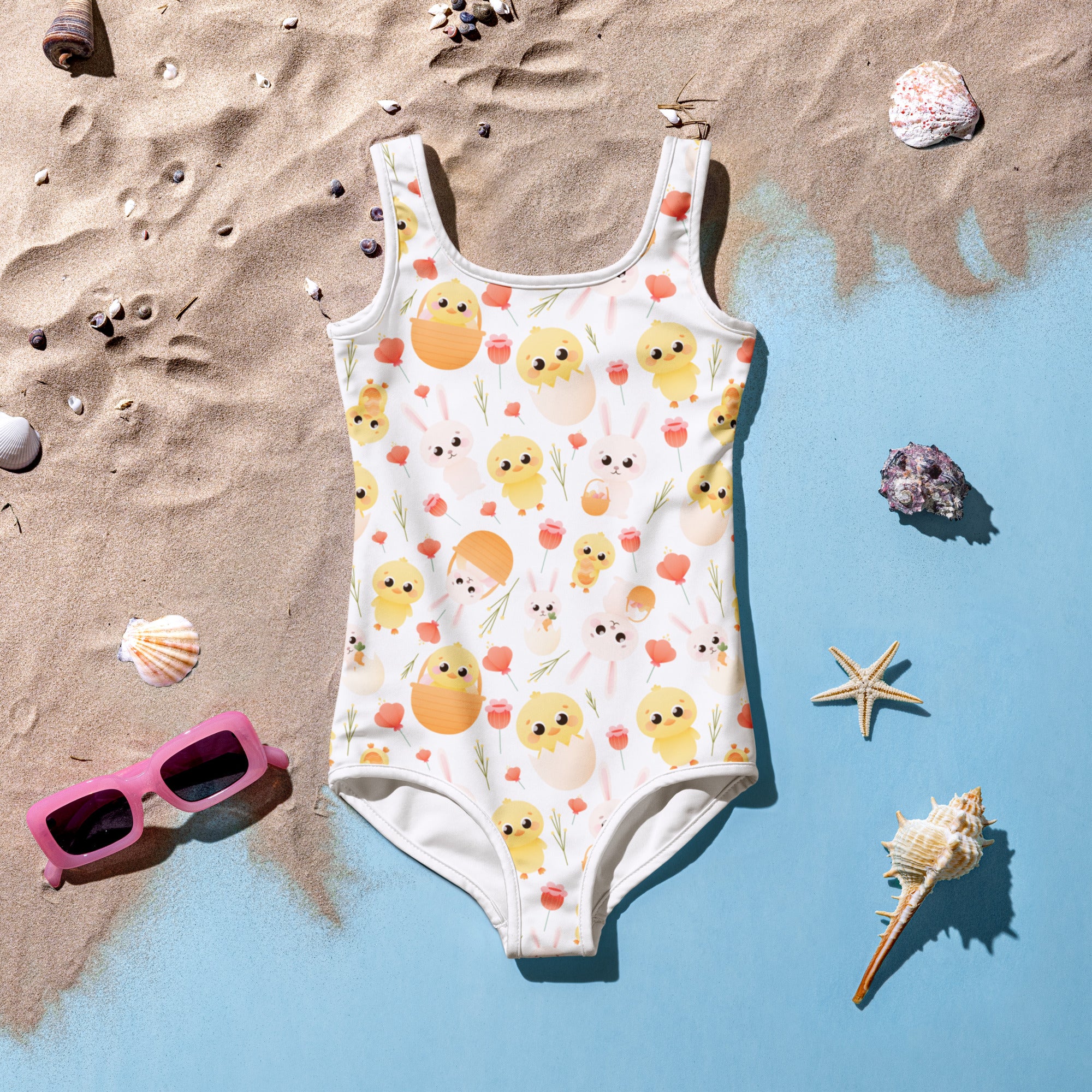 A white girls one-piece swimsuit with yellow chicks orange eggs pink flowers buttery soft fabric and UPF 50+ protection