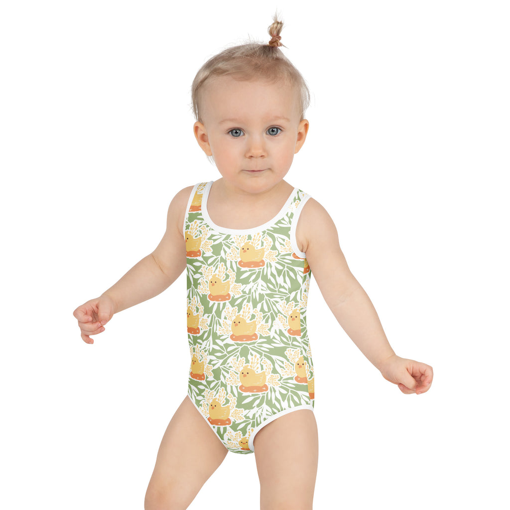 A child wearing a green and yellow duck-themed girls spring chick buttery soft swimsuit with upf 50+ and double layered front