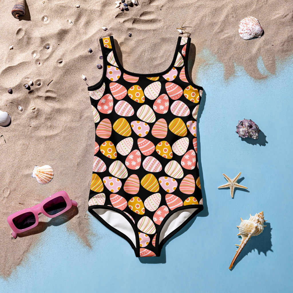 Girls pink Easter egg buttery soft black one-piece swimsuit with vibrant pastel pattern and UPF 50 plus double layered front