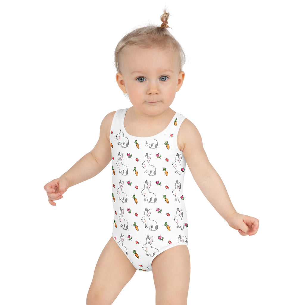 White one-piece girls bunny and carrot easter swimsuit with playful black outline pattern and upf 50 plus buttery soft fabric