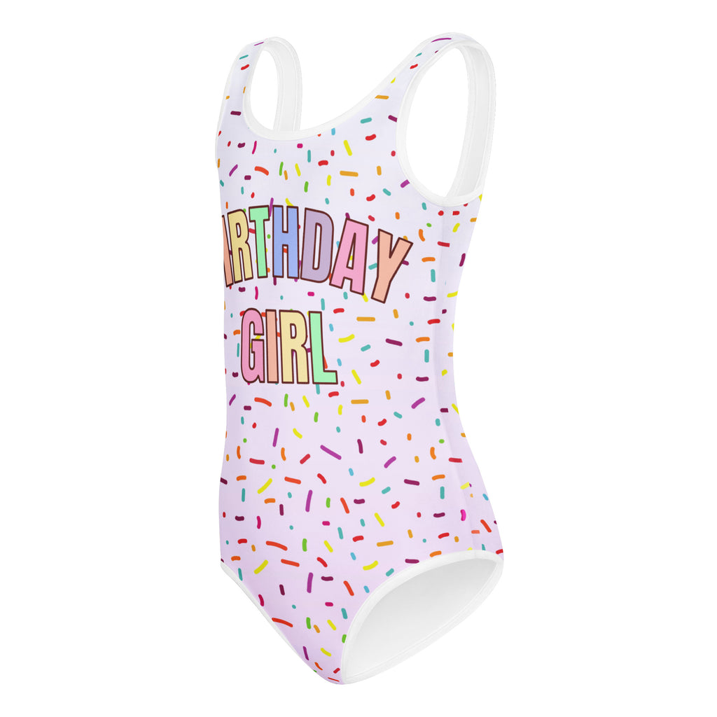White one-piece buttery soft leotard with colorful sprinkles and birthday girl text for dance and gymnastics