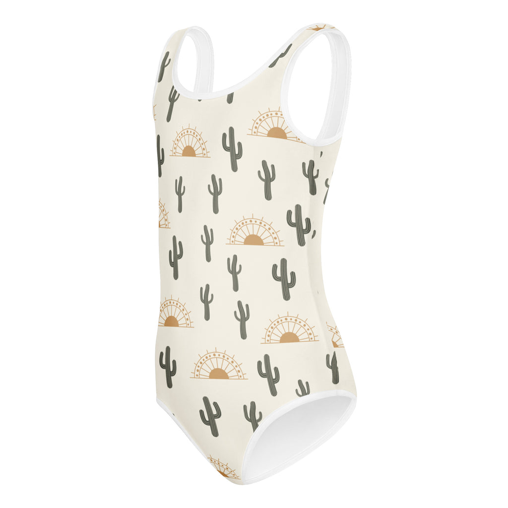 Girls cactus desert sunrise buttery soft cream one-piece swimsuit with black cacti and gold sun patterns for dance and gymnastics