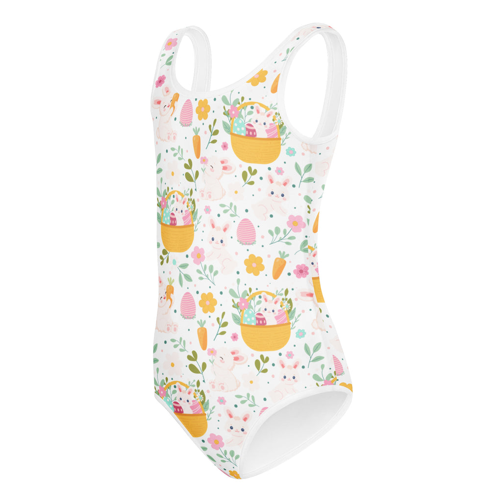 White one-piece buttery soft leotard with playful easter pattern featuring yellow baskets pink eggs carrots and flowers for girls dance and gymnastics