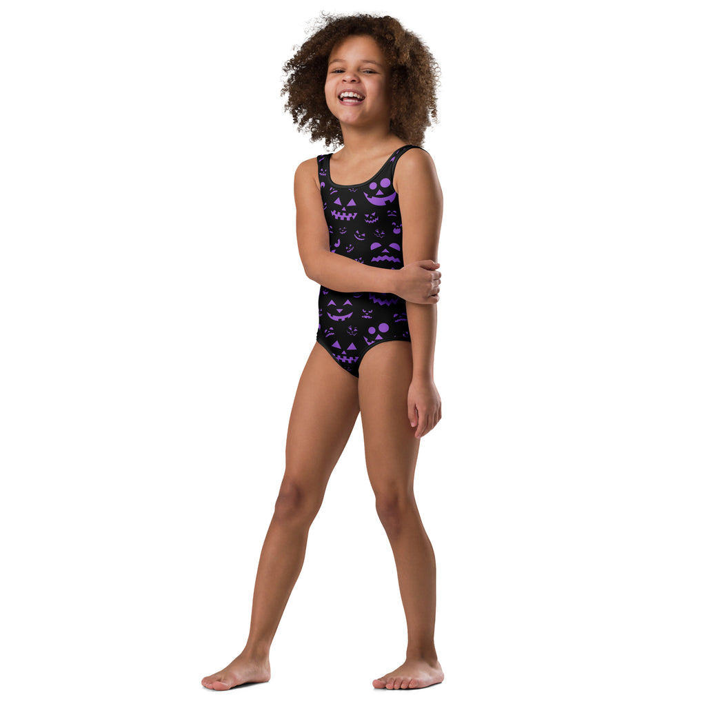 Black one-piece swimsuit with purple jack-o-lantern face patterns made of buttery soft quick-dry fabric for dance and gymnastics