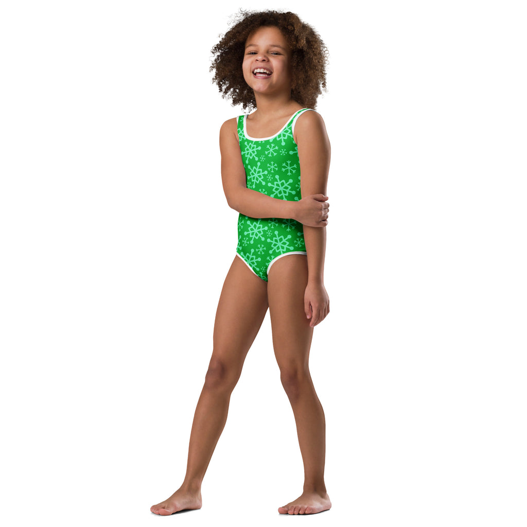 Girls green one-piece leotard with white snowflake pattern and trim made from buttery soft quick-drying fabric