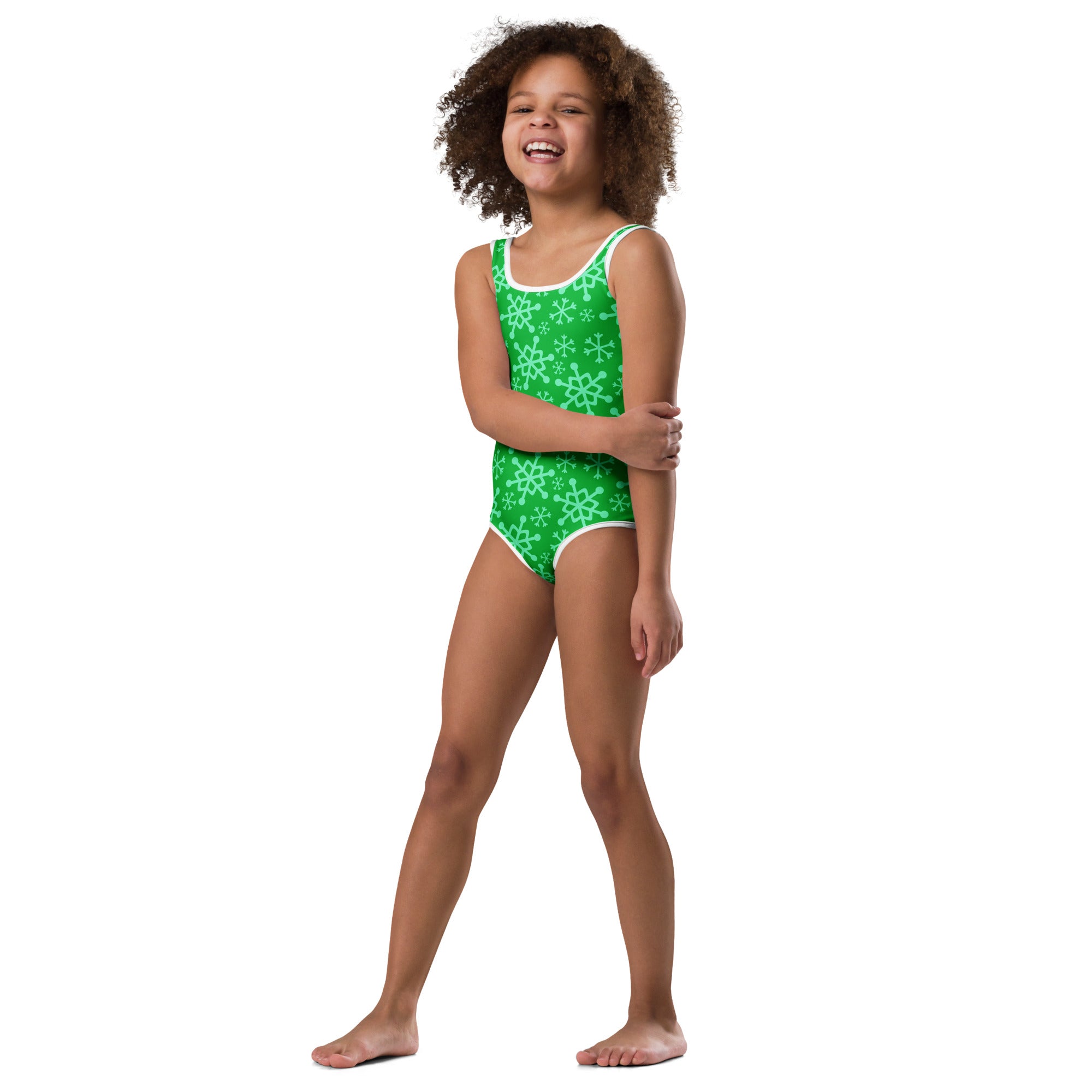 Girls green one-piece leotard with white snowflake pattern and trim made from buttery soft quick-drying fabric