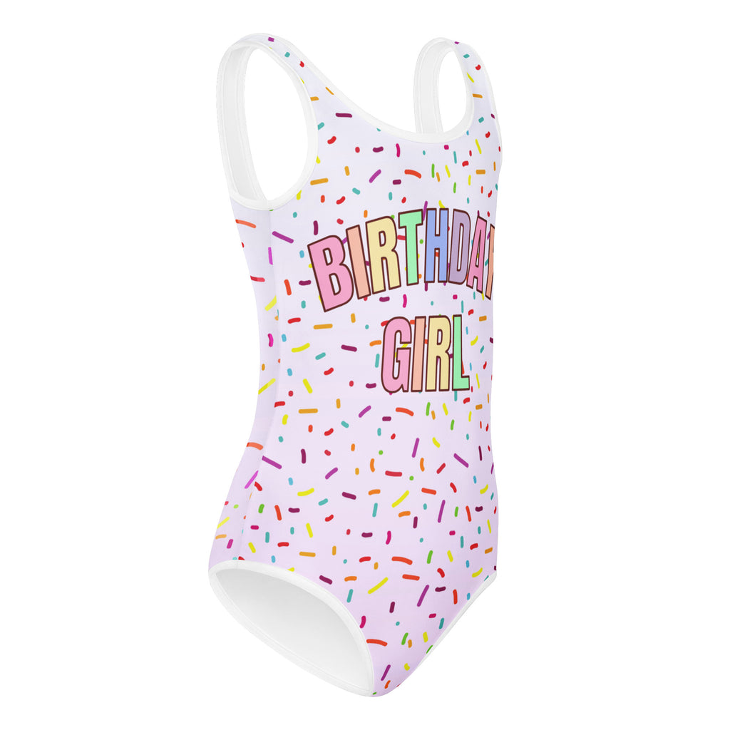 White one-piece buttery soft leotard with colorful sprinkles and birthday girl text for dance and gymnastics