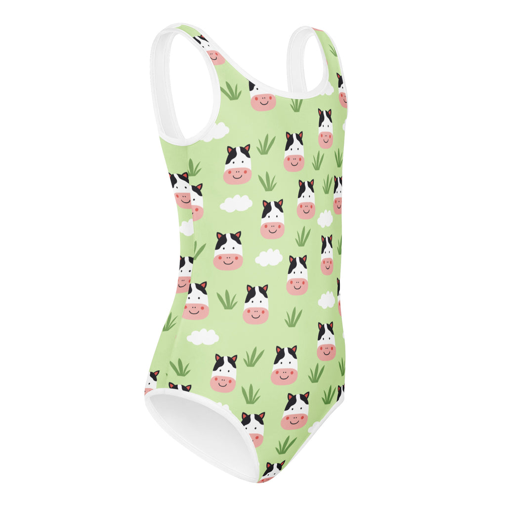 A light green girls cow print buttery soft leotard with white straps and quick drying fabric for dance and gymnastics