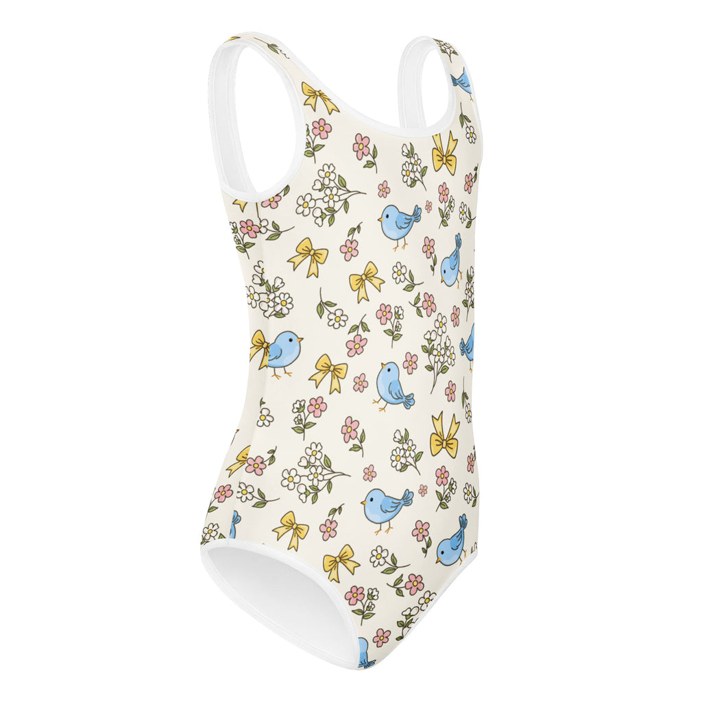 White one-piece girls leotard with blue birds yellow bows and pink flowers quick drying for dance and gymnastics