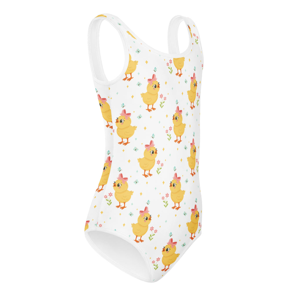 White one-piece swimsuit for girls featuring a playful yellow chick pattern with pink bows and small flowers, quick drying