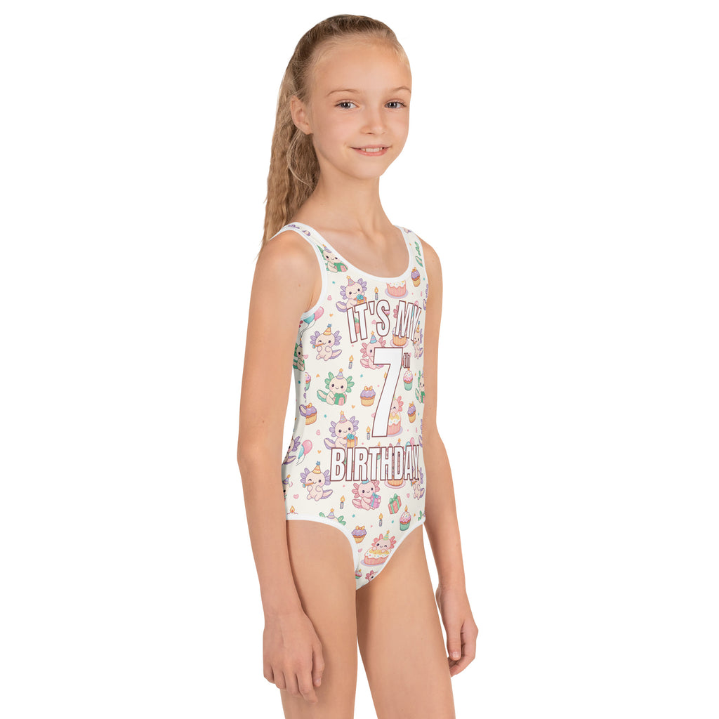 Young girl wearing a swimsuit with birthday-themed design on a white background