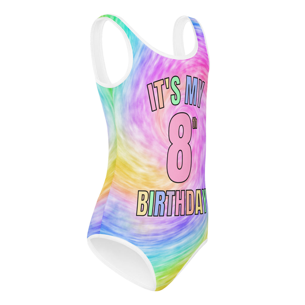 A vibrant rainbow tie dye girls one-piece swimsuit with white trim and colorful its my 8th birthday graphic for dance and gymnastics