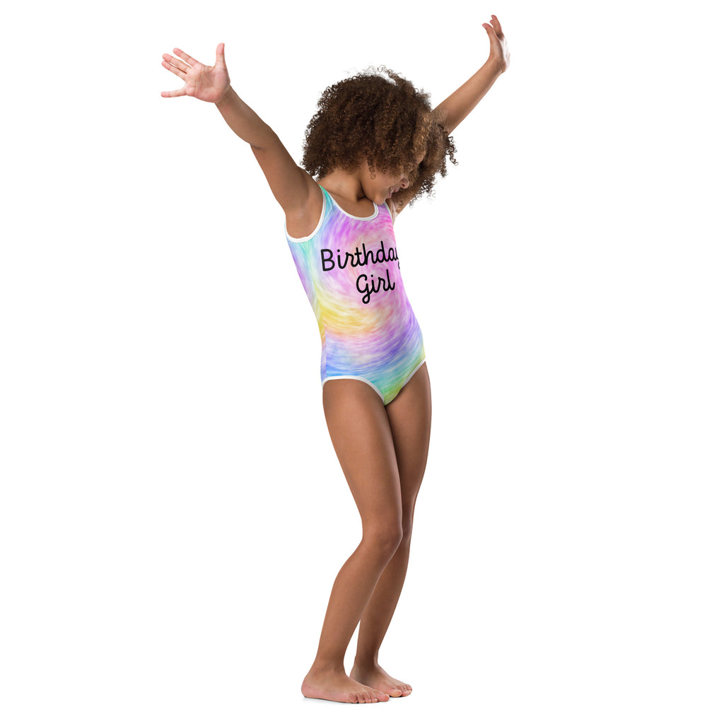 A vibrant rainbow tie dye buttery soft girls birthday girl leotard with black script for dance and gymnastics