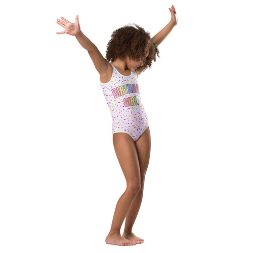 White one-piece buttery soft leotard with colorful sprinkle pattern and rainbow birthday girl text for dance and gymnastics