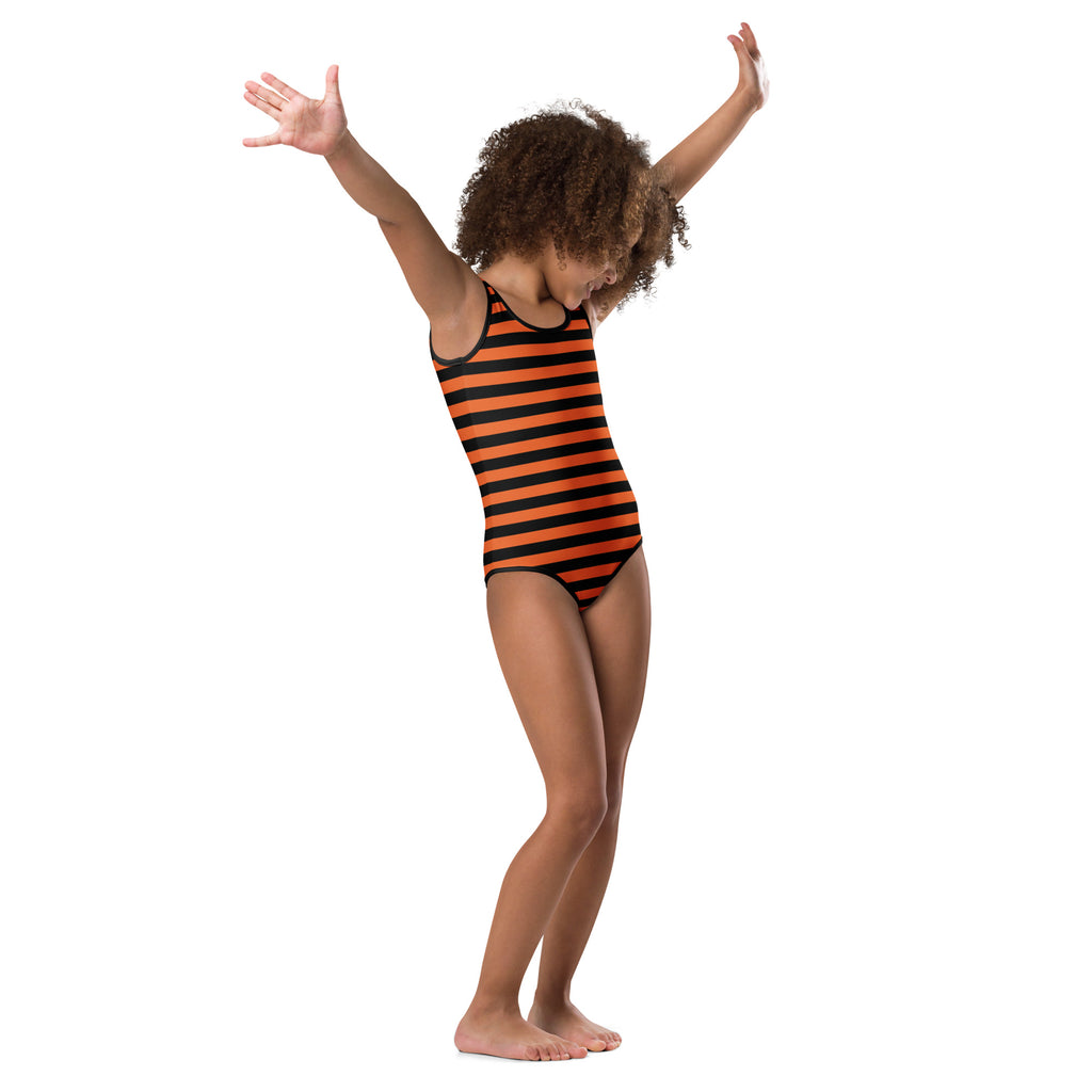 A child wearing the back of a girls orange and black halloween striped buttery soft quick drying leotard for dance and gymnastics