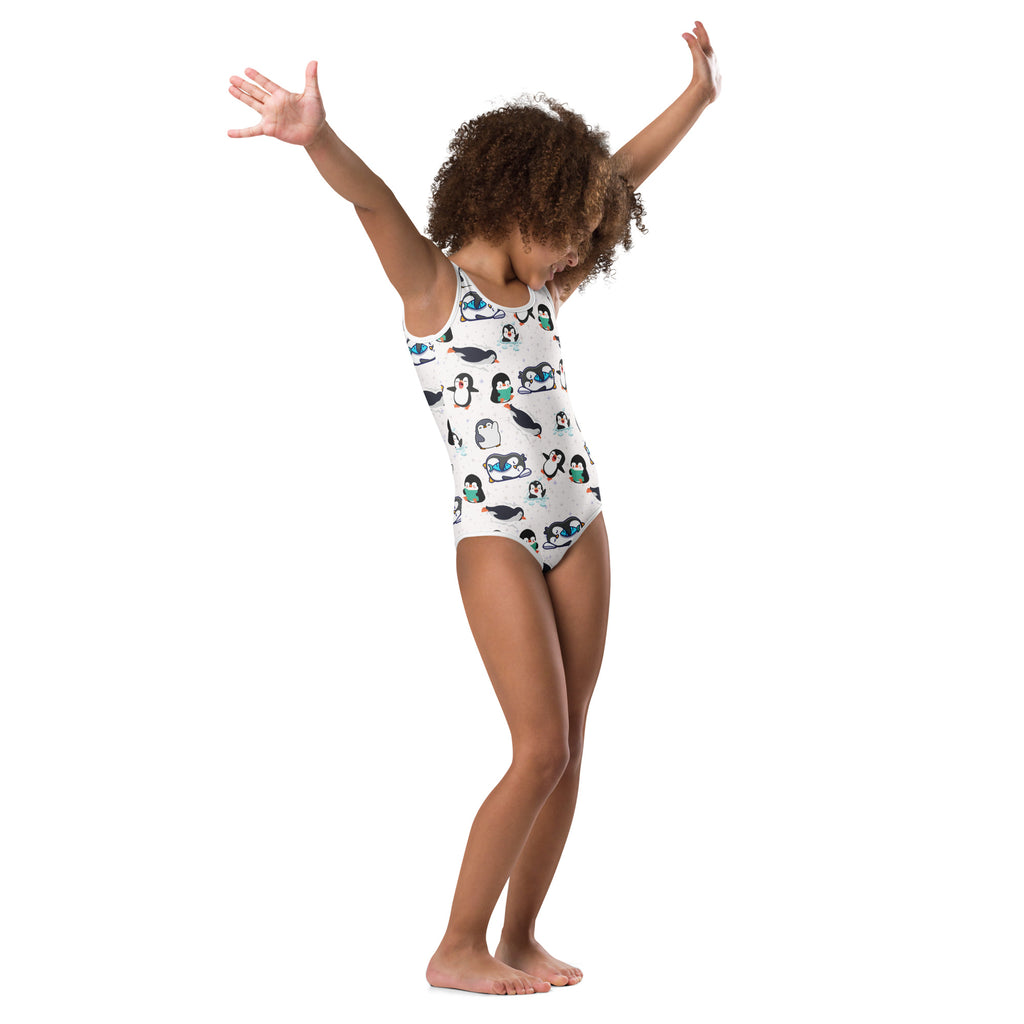 Girls winter penguin buttery soft white leotard with black white and teal cartoon penguin pattern for dance and gymnastics