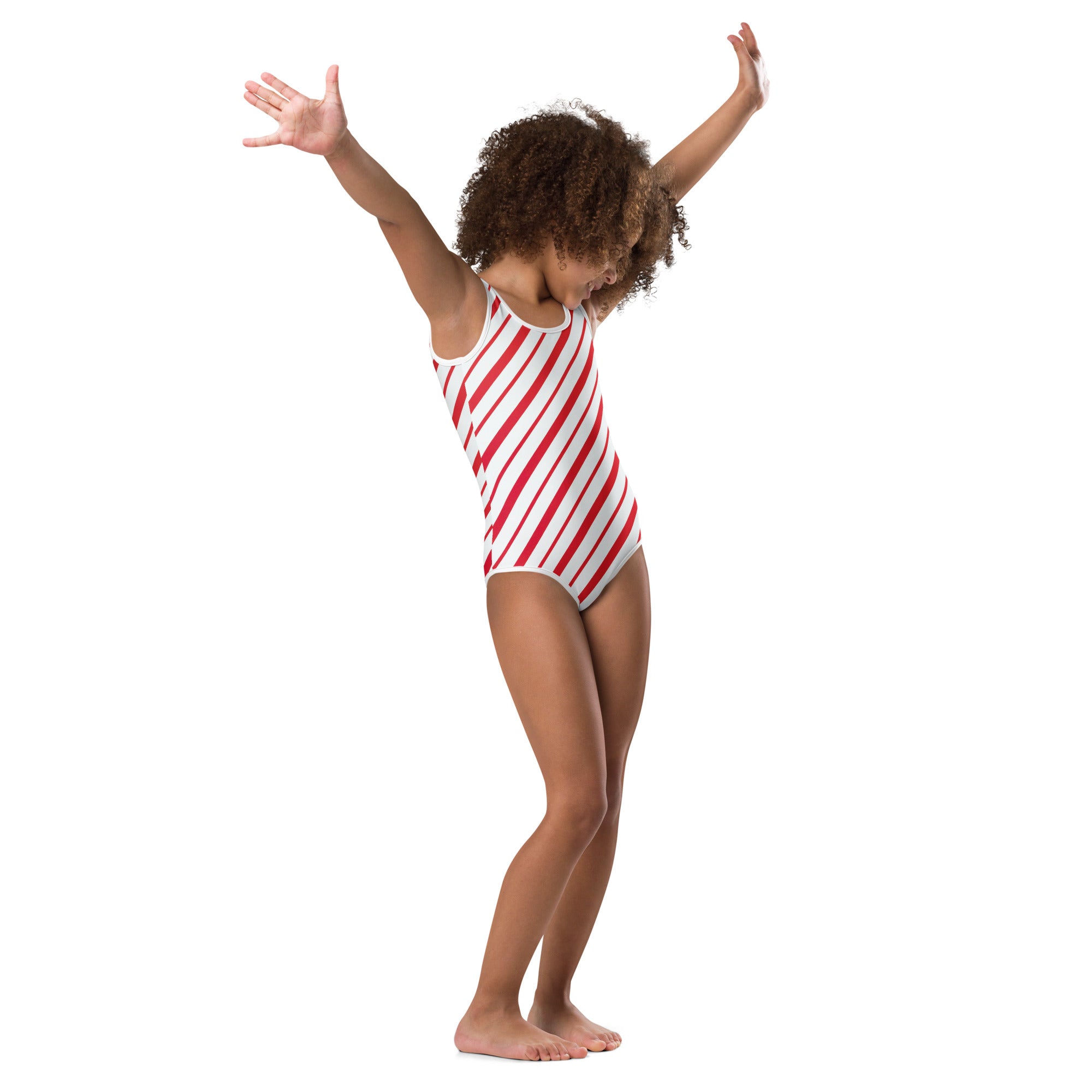 A young girl wearing a red and white candy cane stripe buttery soft leotard for dance and gymnastics