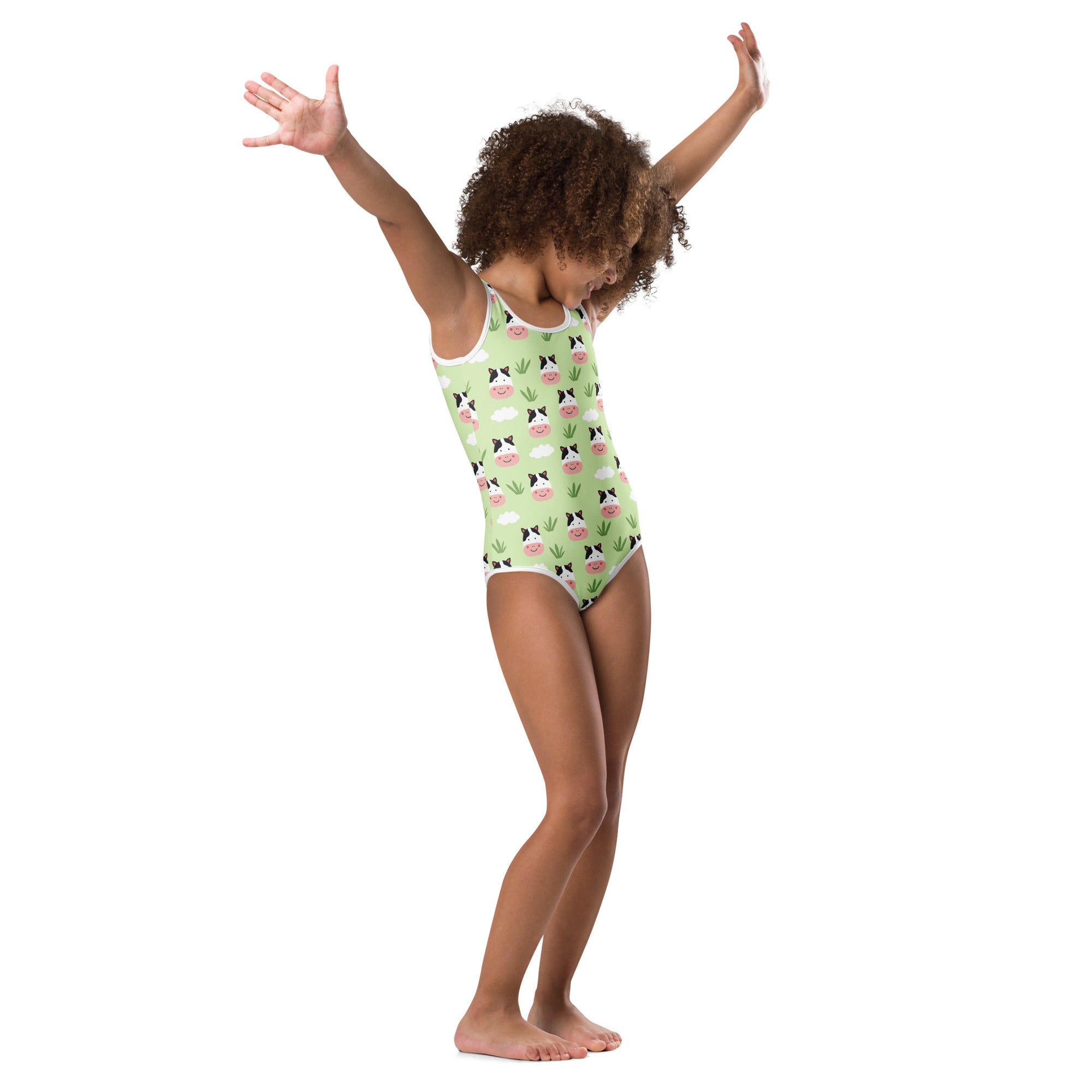 A light green girls cow print buttery soft leotard with white trim and quick drying fabric for dance and gymnastics