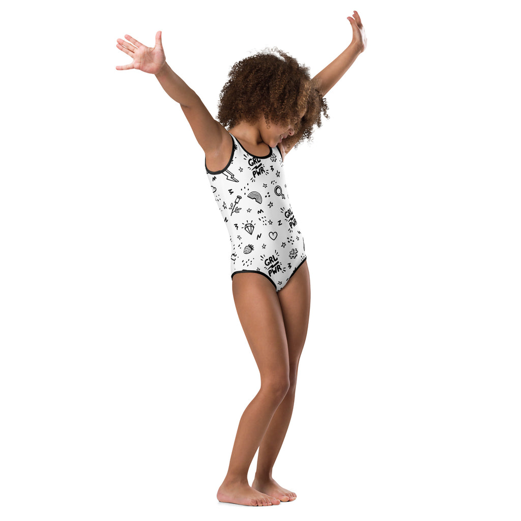 White one-piece buttery soft leotard with black trim and girl power stars hearts rainbows pattern for dance and gymnastics