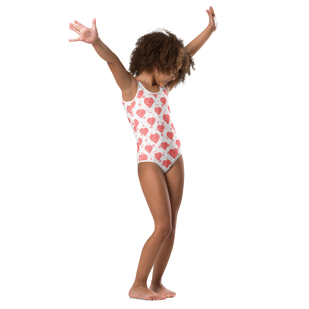 White one-piece girls leotard with pink heart pattern made of buttery soft quick drying fabric for dance and gymnastics