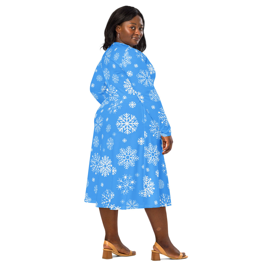Women’s blue a-line midi dress with long sleeves and white snowflake pattern featuring pockets
