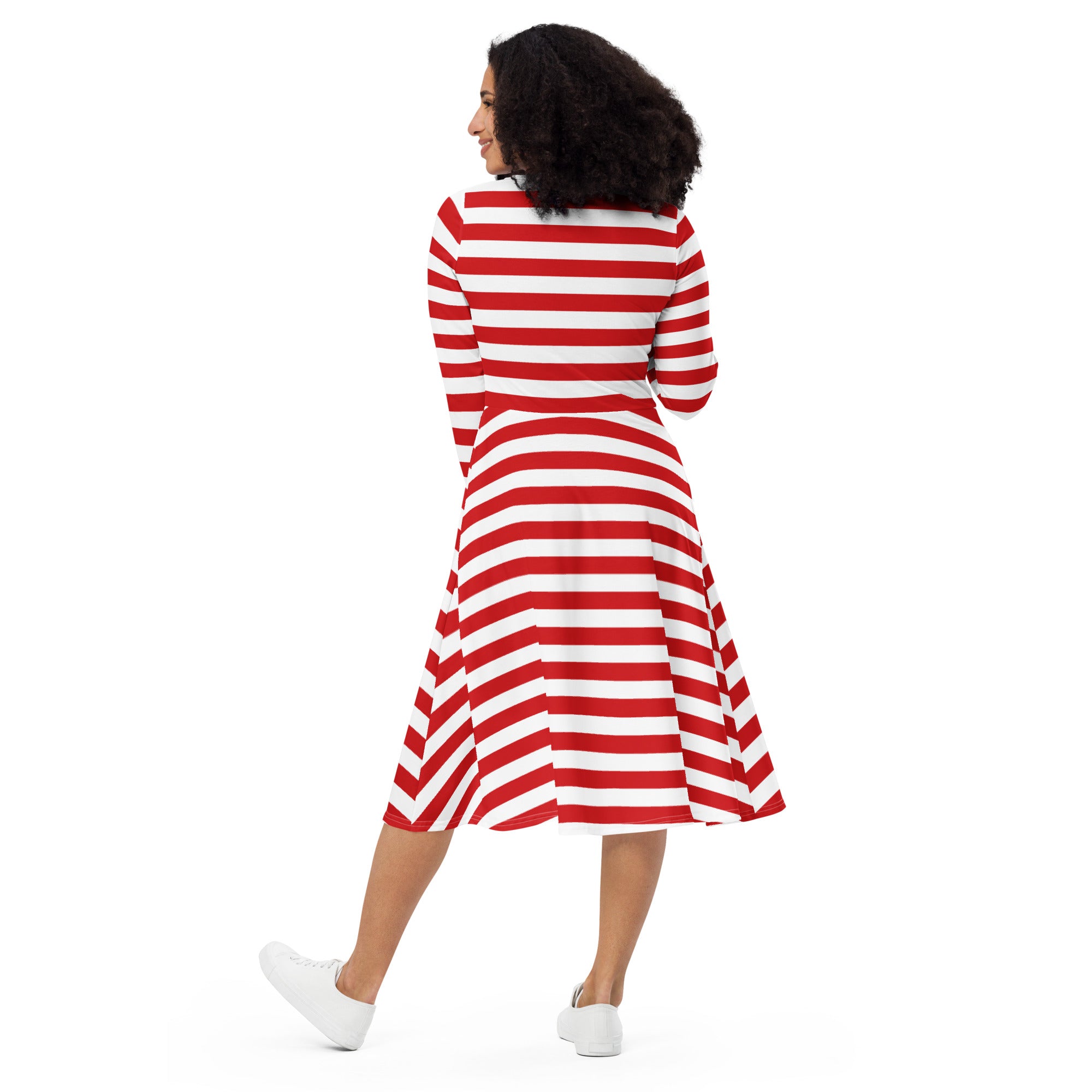 A woman wearing a red and white striped long sleeve midi dress with fitted waist and pockets