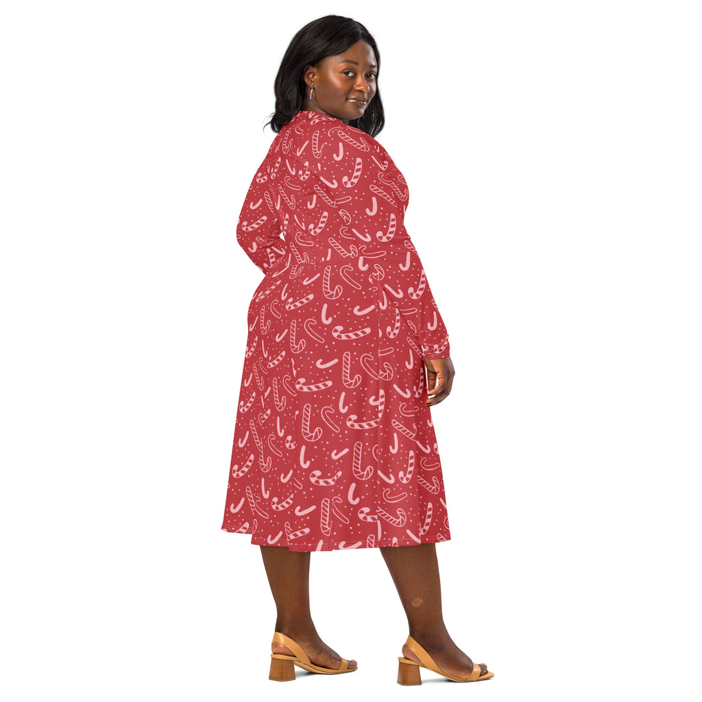 Women’s red long sleeve midi dress with playful white candy cane pattern and pockets perfect for christmas festivities