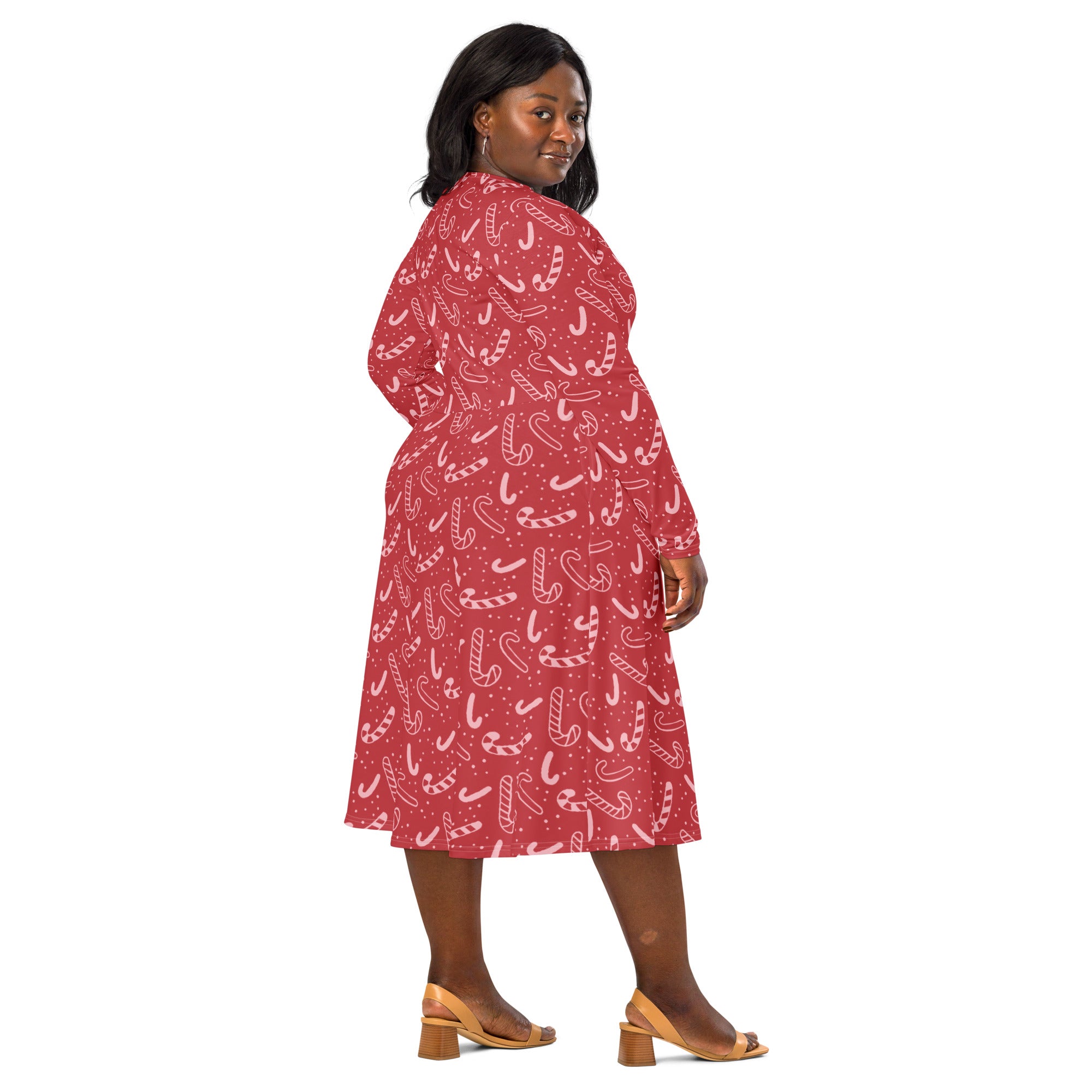 Women’s red long sleeve midi dress with playful white candy cane pattern and pockets perfect for christmas festivities
