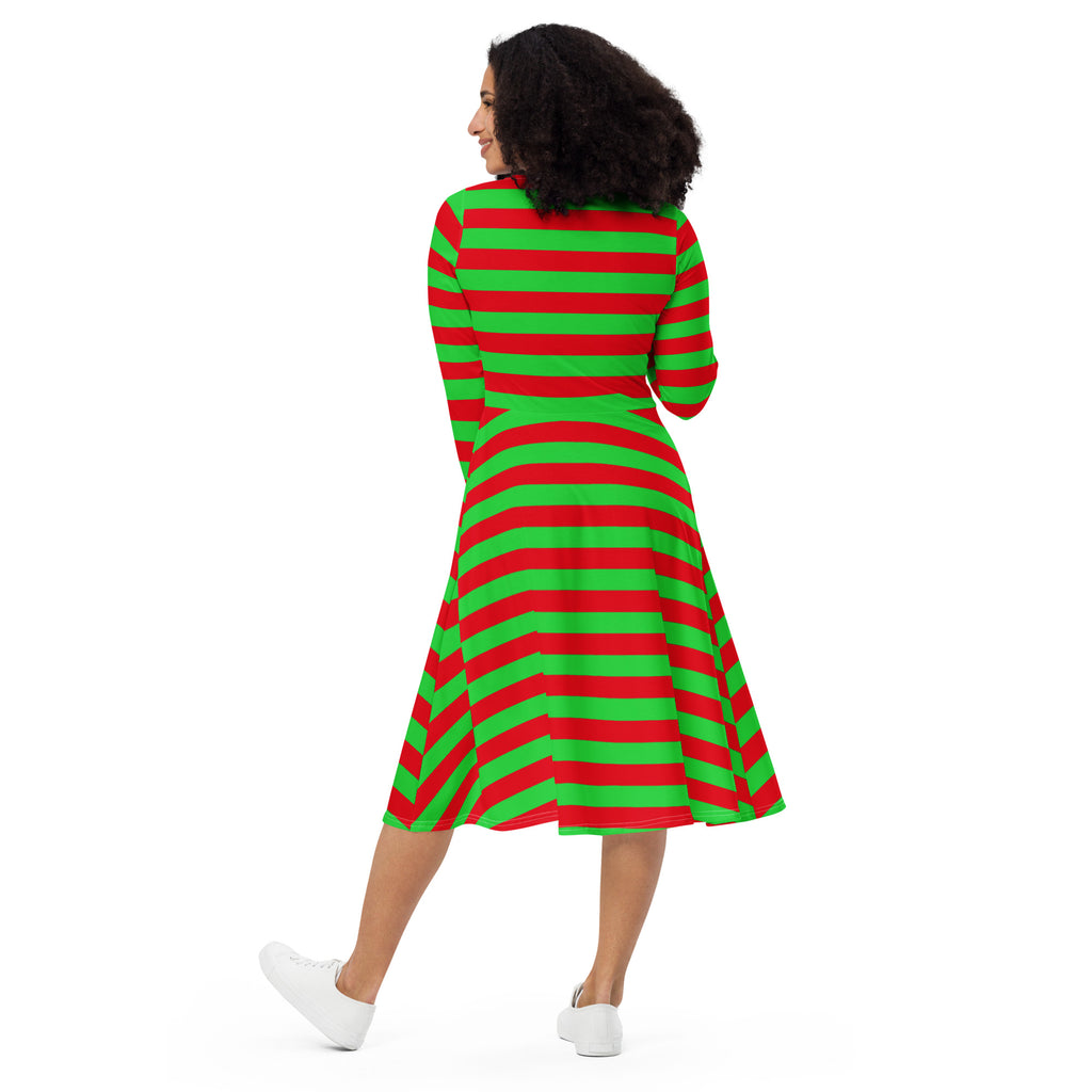 A woman wears a women’s red and green long sleeve midi dress with pockets featuring festive stripes